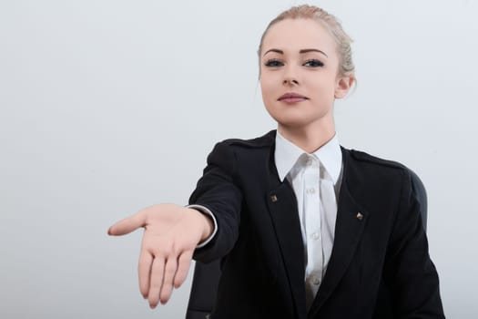 professional female officer in a black uniform extends her hand with a polite smile, requesting the necessary documents. Despite her courteous demeanor, her firm expression shows shes assertive and