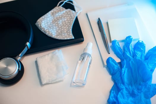 Sanitizer anti virus spray on the working table with laptop. Personal hygiene concept. Concept of quarantine for coronavirus and working from home.