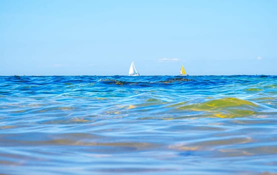 Boats and waves seen by a swimmer at sea level, photography taken in Vendée, France