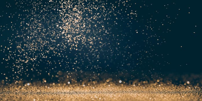 Luxury abstract glitter bokeh background. New year and christmas holiday party design. Golden star dust light sparkling on dark backdrop.