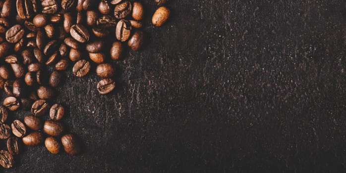Coffee beans on rustic black background from above. Coffee shop creative menu design layout. Dark vintage banner with arabian coffee top view.