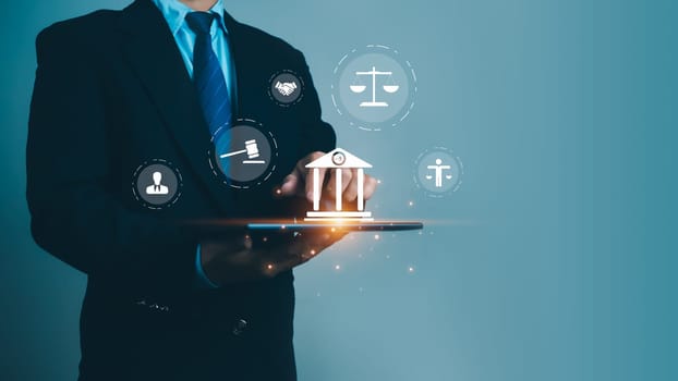 Businessman holding tablet and virtual global law icons on for business legal advice, Labor law, Lawyer, Attorney at law, Legal advice business concept, Lawyer icon, Lawyer man, Lawyer background.