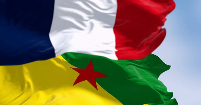Flags of French Guiana and France waving in the wind on a clear day. Overseas department, region and single territorial collectivity of France. 3d illustration render. Selective focus. Rippling fabric