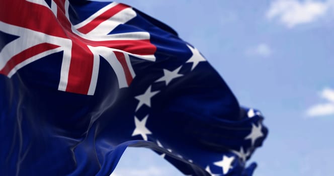 Close-up of the Cook Islands National flag waving in the wind on a clear day. a self-governing island country in the South Pacific Ocean. 3d illustration render. Selectiv focus. Rippling fabric