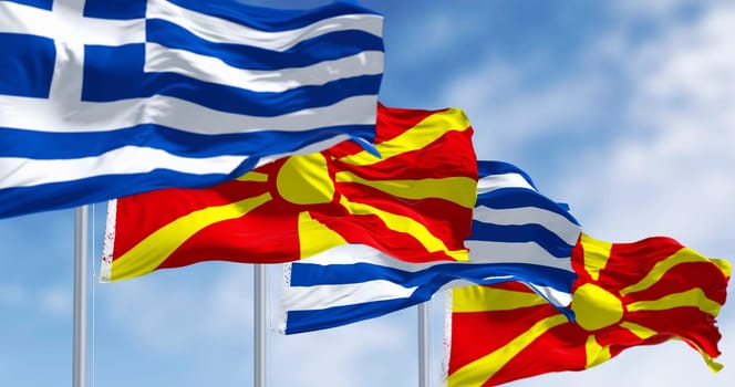 Flags of Greece and North Macedonia waving in the wind on a clear day. 3d illustration render. Fluttering fabric. Selective focus