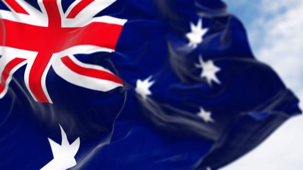 Close-up of Australia national flag waving in the wind on a clear day. Blue flag with Union Jack, white 5-pointed star symbolizing Southern Cross. 3D illustration render. Selective focus