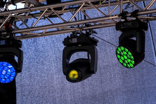 Spotlights for lighting a stage are suspended from a mounting scaffold.