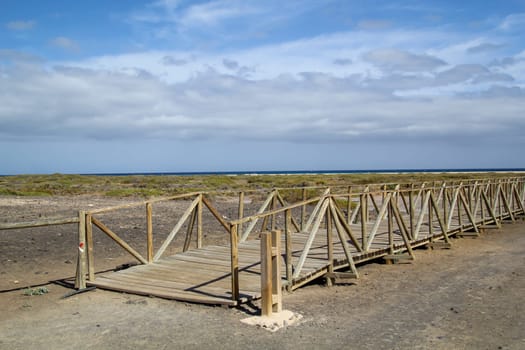 A wooden walkway guides visitors to the beach through nature, which is worth protecting.