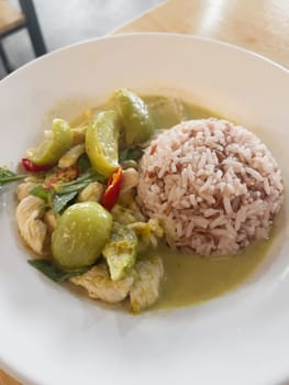 Thai green curry with chicken on jasmine rice, stock photo
