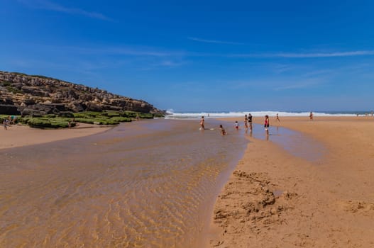 Sintra, Portugal: April 13, 2024: People at the beach of Foz do Lizandro, Ericeira, Portugal