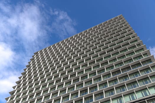 Modern office building facade with repeating geometric pattern in Tokyo