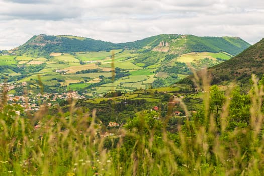 View over Millau town with Causse du Larzac limestone plateau, listed as UNESCO World Heritage Site. Department of Aveyron, France