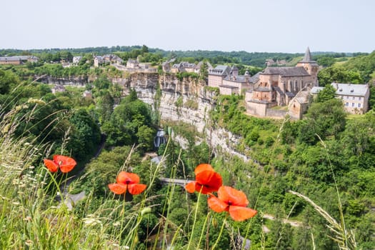 The Trou de Bozouls framed with poppies in Aveyron, Occitanie, France