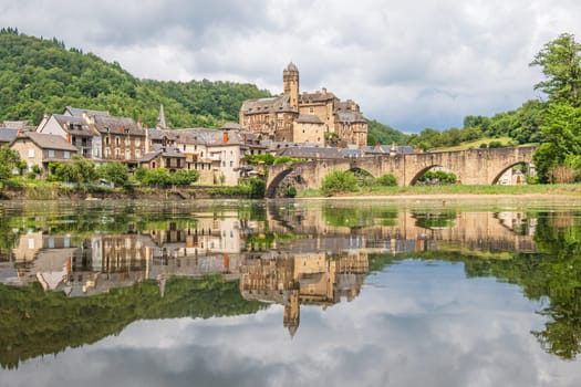 Estaing village, castle and medieval bridge over Lot river photographed in Aveyron, one of the most beautiful villages of France