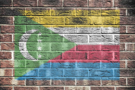 A Comoros flag on an old brick wall background