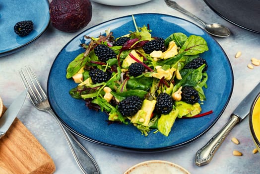 Green vitamin salad with blackberries, microgreens, avocado and pine nuts. Rustic style.