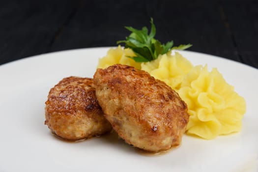Chicken meat cutlet with mashed potatoes on white plate
