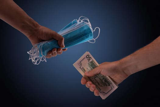 Sell - buy medical face mask concept. Hands holding protective face masks and nany US dollars banknote a lot of at.