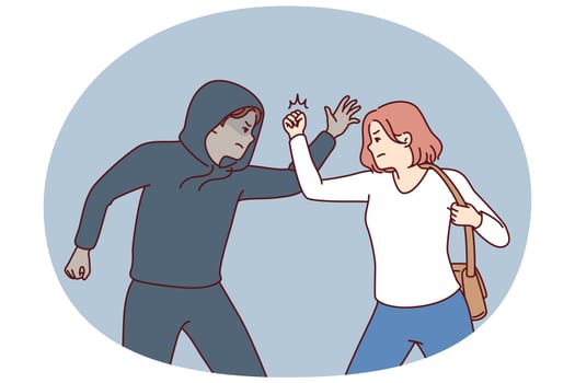 Strong woman fights back against thief by showing self-defense techniques to man who tried to steal purse and commit crime. Self-defense and martial art concept of krav maga against street thug