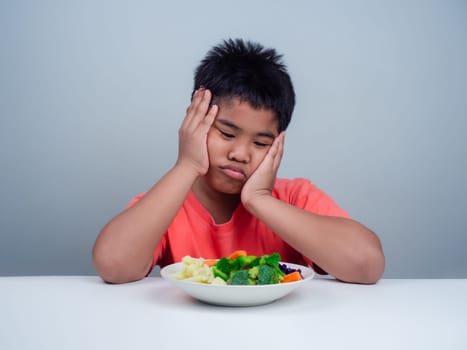 Children do not like to eat vegetables, Little cute boy refuses to eat healthy vegetables, Nutrition healthy eating habits for kids concept, Children do not like to eat vegetables.