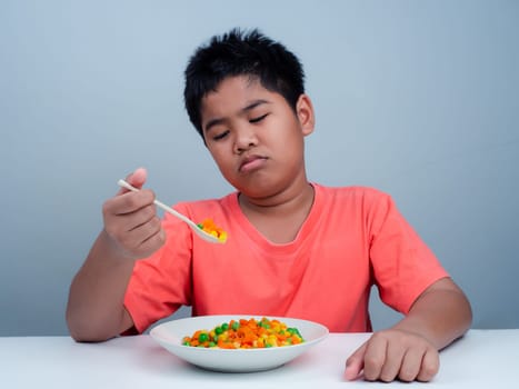 Children do not like to eat vegetables, Little cute boy refuses to eat healthy vegetables, Nutrition healthy eating habits for kids concept, Children do not like to eat vegetables.