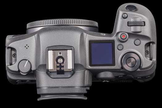 black 2020s professional 35mm full-frame mirrorless camera body with flip screen isolated on black background.