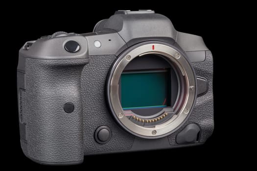 black 2020s professional 35mm full-frame mirrorless camera body with flip screen isolated on black background.