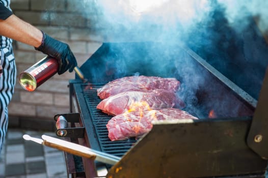 Pork meat steaks on the grill with flames