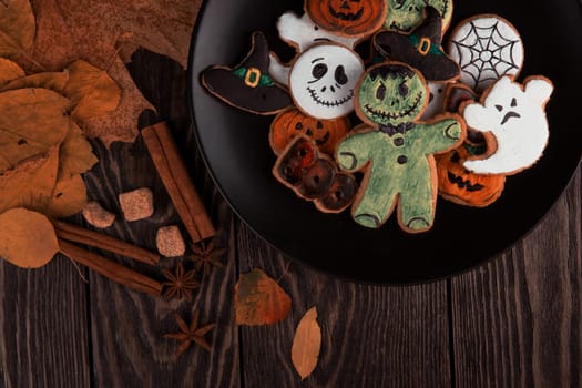 Ginger biscuits for Halloween holiday on wooden table with copy space