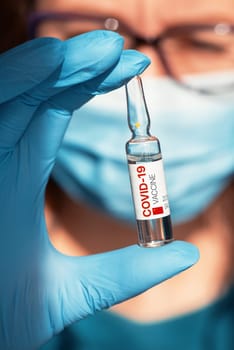 Coronavirus China-developed vaccine concept: vaccine with China flag in doctor hand with blue protective gloves.