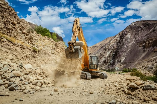 Excavator doing road construction repair in Himalayas. Ladakh, Jammu and Kashmir, India
