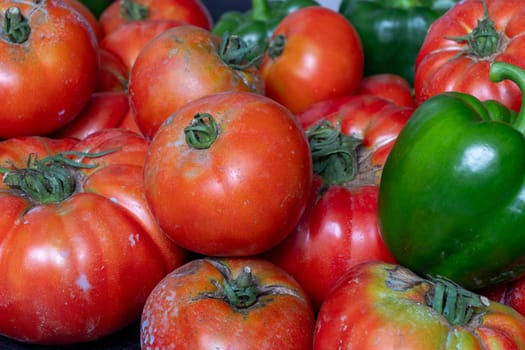 A bunch of red and green tomatoes and peppers
