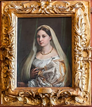 Florence, Italy - 23 September 2023: Pitti Palace antique painting museum. The vailed woman - La velata - by Raphael - Raffaello Sanzio, 1514.