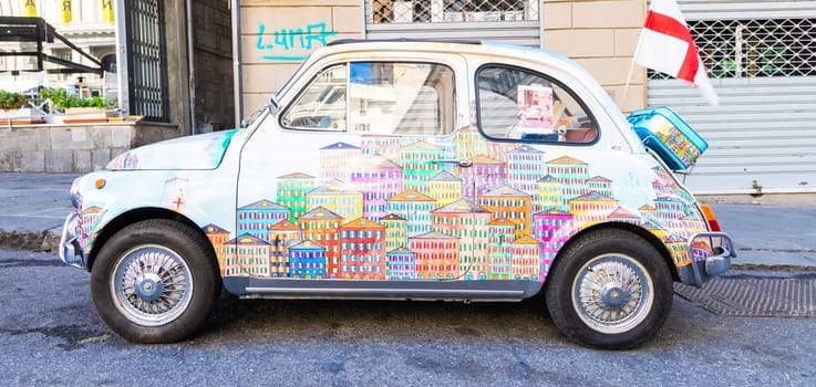 Genova, Italy - 6 August 2023: vintage Fiat 500 car painted with traditional cityscape of Liguria Region - Italy travel destination