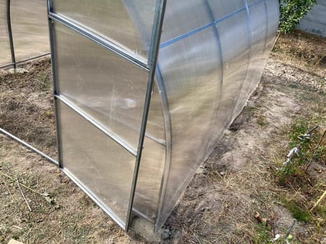 Installation of a metal frame greenhouse with the polycarbonate covering