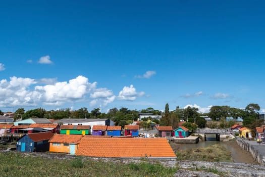 A colorful village with many houses and a river in the background, Oleron Island, France