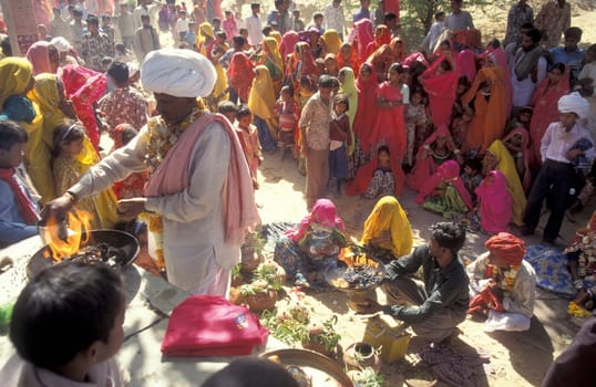 Traditional dresst Rajasthani People on the way home after a traditional Funeral in the Town of Pushkar in the Province of Rajasthan in India.  India, Pushkar, January, 1998
