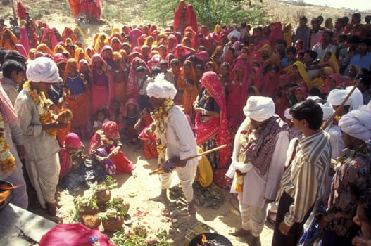 Traditional dresst Rajasthani People on the way home after a traditional Funeral in the Town of Pushkar in the Province of Rajasthan in India.  India, Pushkar, January, 1998