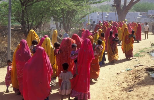 Traditional dresst Rajasthani People on the way home after a traditional Funeral in the Town of Pushkar in the Province of Rajasthan in India.  India, Pushkar, January, 1998