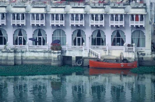 Architectur with Palace and Houses on the Pichhola Lake in the Town of Udaipur in the Province of Rajasthan in India.  India, Udaipur, January, 1998