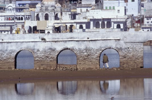 Architectur with Palace and Houses on the Pichhola Lake in the Town of Udaipur in the Province of Rajasthan in India.  India, Udaipur, January, 1998