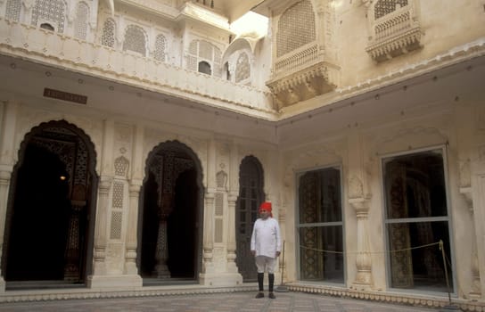 a Rajasthani men in traditional dress at the City Palace Hotel in the Town of Udaipur in the Province of Rajasthan in India.  India, Udaipur, January, 1998