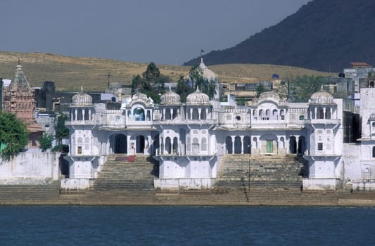 Architectur with Palace and Houses on the Pichhola Lake in the Town of Udaipur in the Province of Rajasthan in India.  India, Udaipur, January, 1998