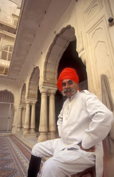 a Rajasthani men in traditional dress at the City Palace Hotel in the Town of Udaipur in the Province of Rajasthan in India.  India, Udaipur, January, 1998