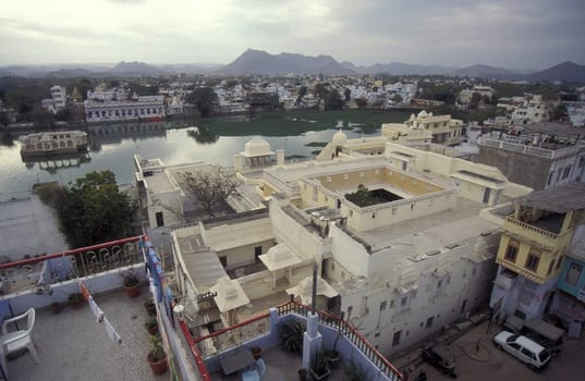 Architectur with Palace and Houses on the Pichhola Lake in the Town of Udaipur in the Province of Rajasthan in India.  India, Udaipur, January, 1998