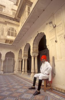 a Rajasthani men in traditional dress at the City Palace Hotel in the Town of Udaipur in the Province of Rajasthan in India.  India, Udaipur, January, 1998