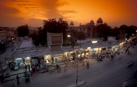 a Road with Hauses and Shops in the evening in the Town of Udaipur in the Province of Rajasthan in India.  India, Udaipur, January, 1998