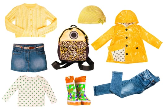 Collage set of little girl autumn clothes isolated on white. Kids apparel collection. Childs fashion clothing outfit. Jeans, skirt, shorts, shirts, jacket, boots, bag and shoes.