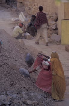 two Rajasthani women at a construction work in the Town of Jaisalmer in the Province of Rajasthan in India.  India, Jaisalmer, January, 1998