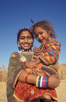 ortrait of a Rajasthani women with her Baby in the Town of Jaisalmer in the Province of Rajasthan in India.  India, Jaisalmer, January, 1998